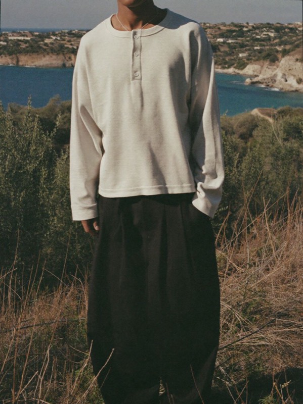 Cropped Waffle Henley with wide dark trousers on a coastal hillside